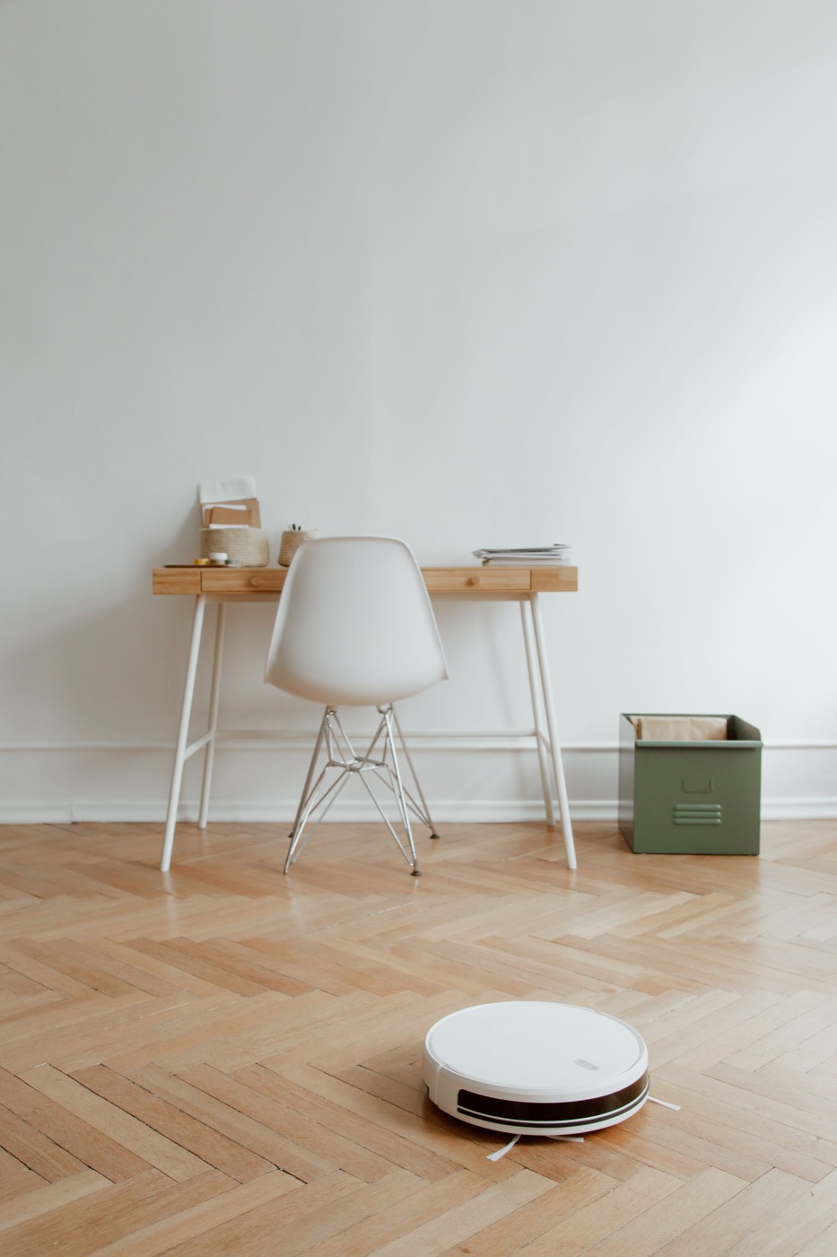 A robot vacuum on the floor of a home office